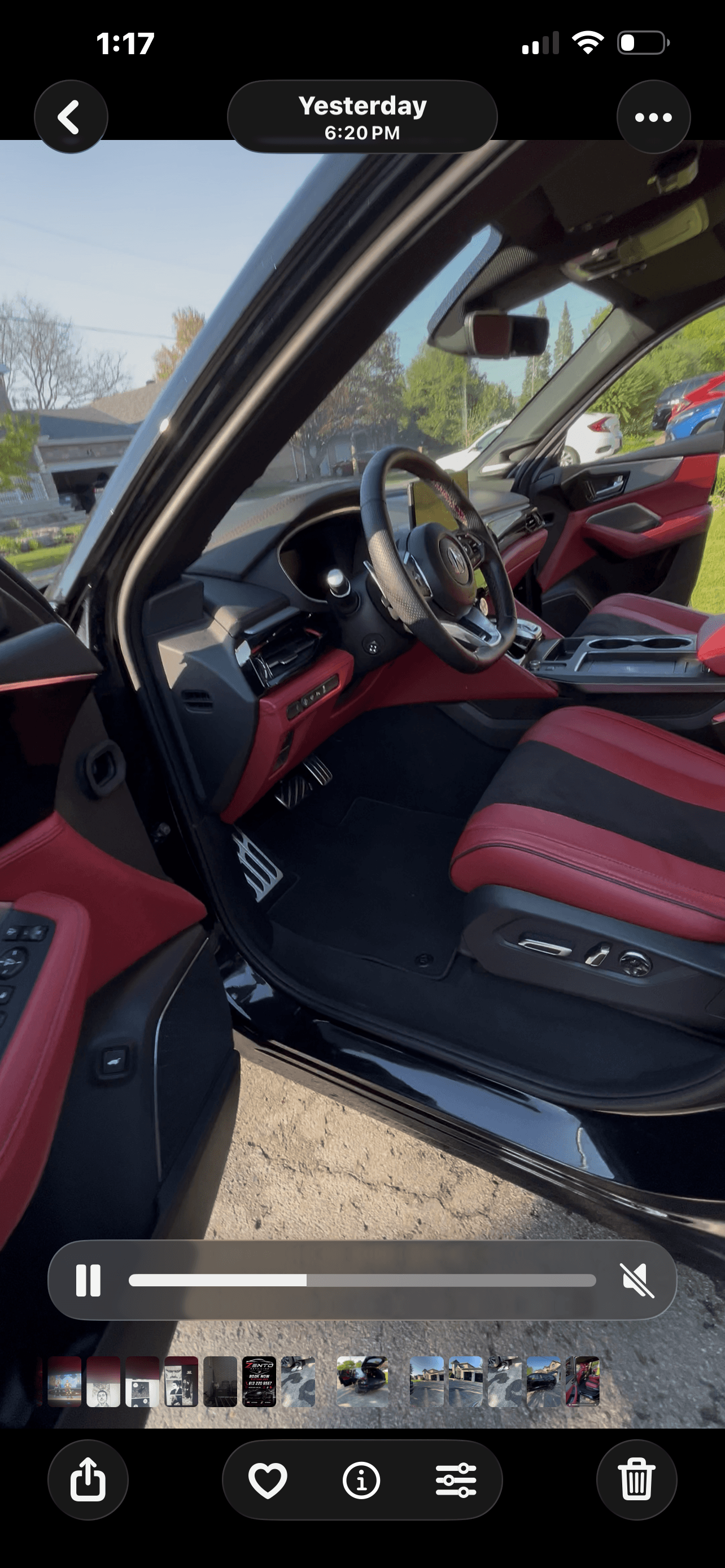 Interior of a modern vehicle with striking red and black leather seats and matching dashboard details.